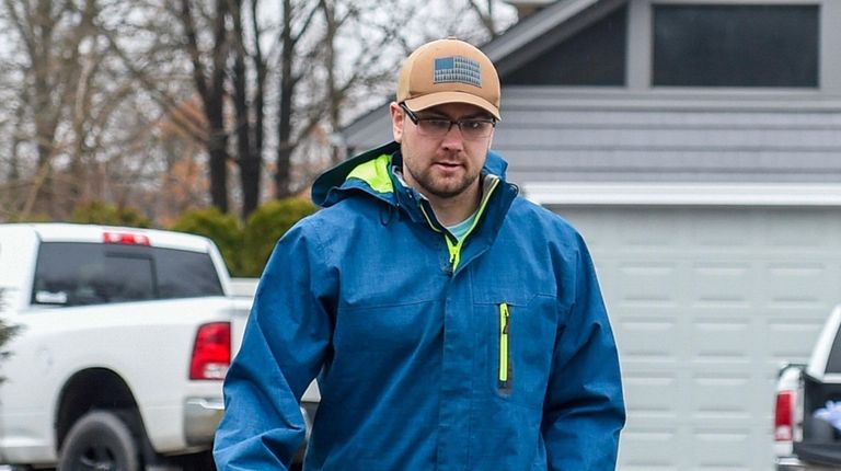 Gerard Chasteen walks down the driveway of his