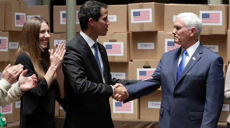 Venezuelan opposition leader Juan Guaidó shakes hands Monday
