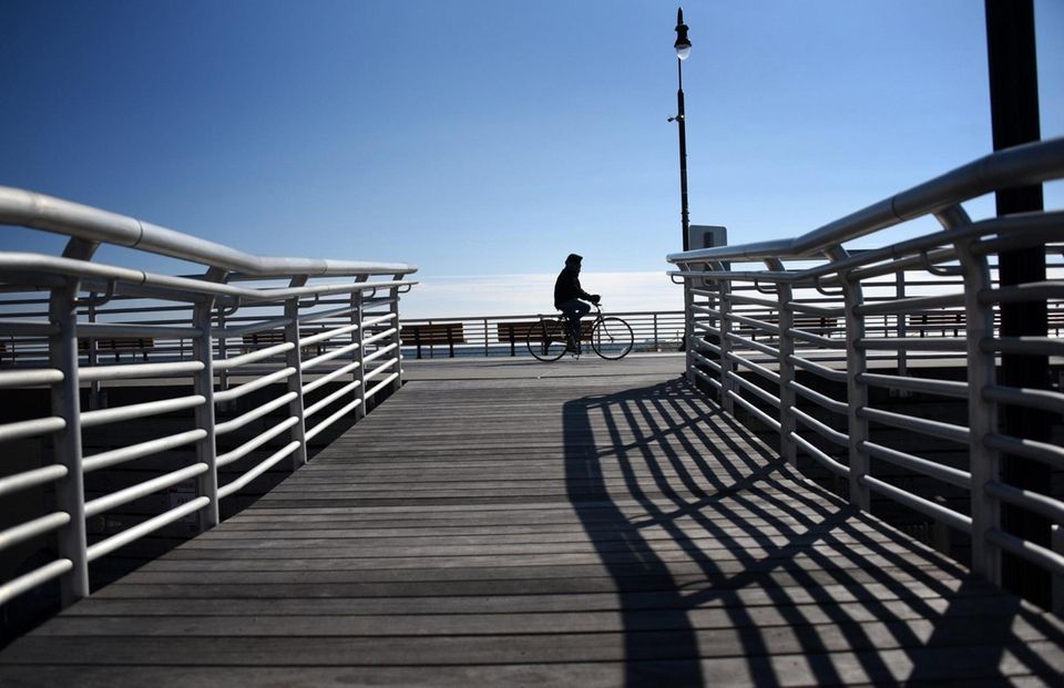 A biker rides along the boardwalk in Long