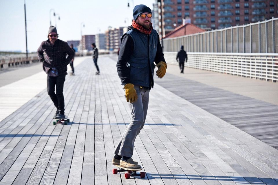Skateboarders take advantage of a breezy but sunny