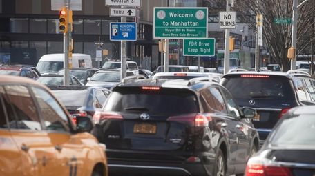 Vehicles arrive in Manhattan after crossing the Williamsburg