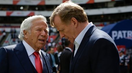 NFL Commissioner Roger Goodell, right, talks with