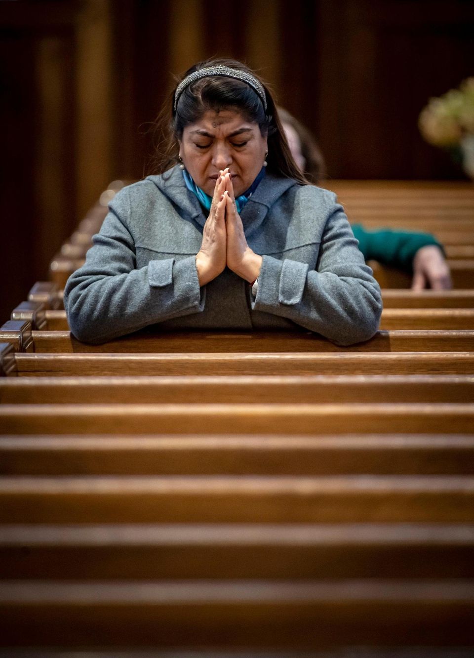 Greta Lozada of Baldwin praying St. Agnes Parish