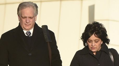 Edward and Linda Mangano leave federal court in