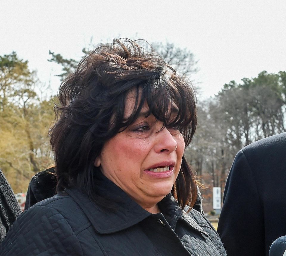 Tears roll down Linda Mangano's face after she