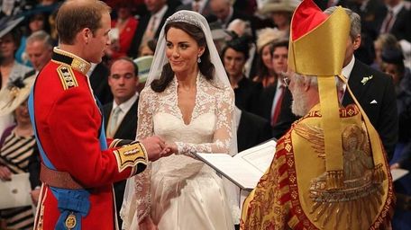 Britain's Prince William and Kate Middleton exchange rings