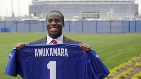 Giants first-round draft pick Prince Amukamara holds up