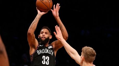 Allen Crabbe takes a three-point shot against the