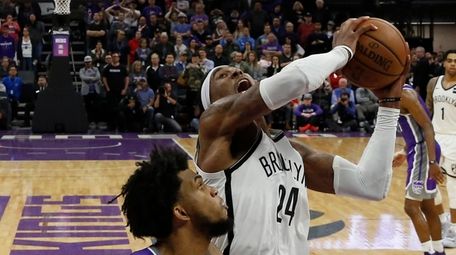 Nets forward Rondae Hollis-Jefferson, right, goes up for