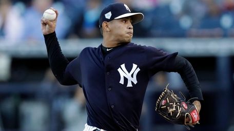 The Yankees' Jonathan Loaisiga pitches to the Phillies