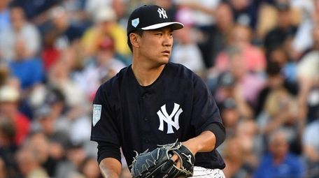Masahiro Tanaka #19 of the Yankees pitches in