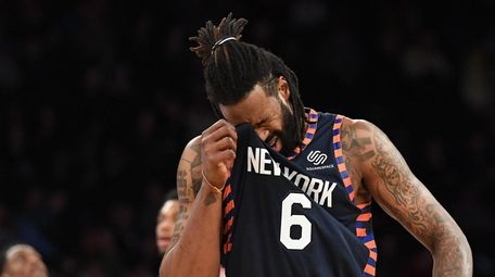 Knicks center DeAndre Jordan wipes his face on
