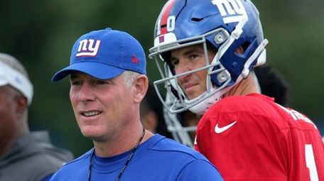 Giants quarterback Eli Manning watches as head coach