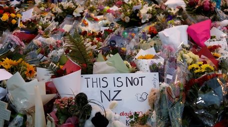 Flowers lay at a memorial near the Masjid