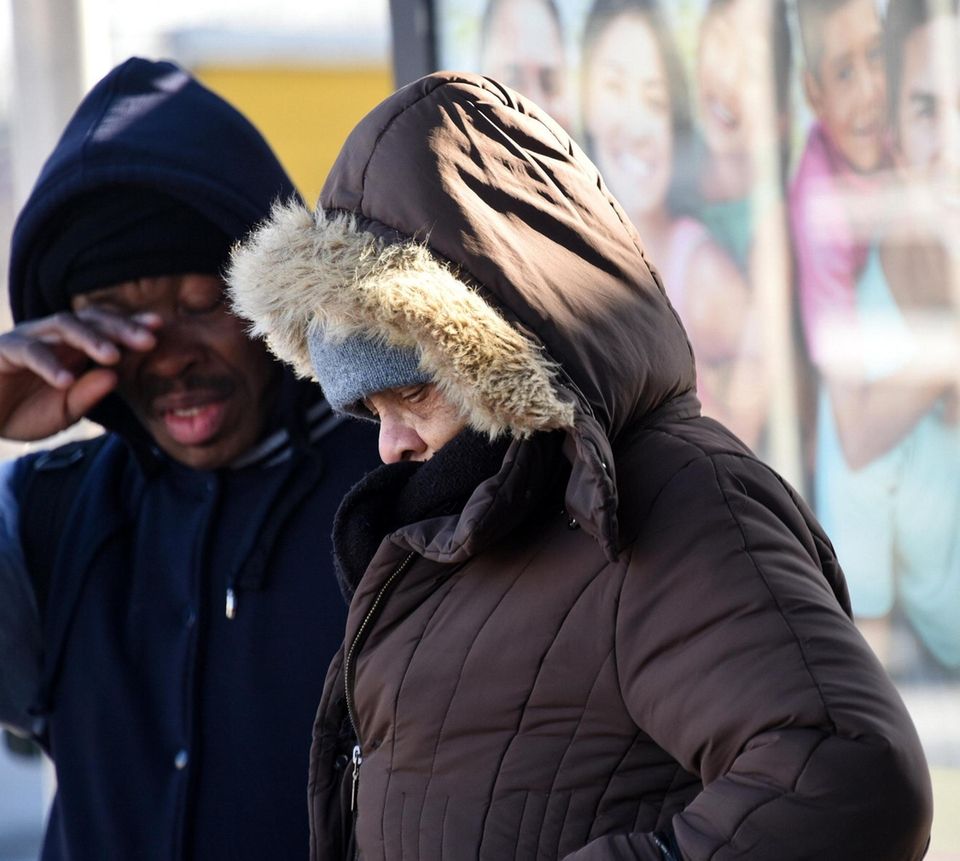 People wait for the bus in Elmont in