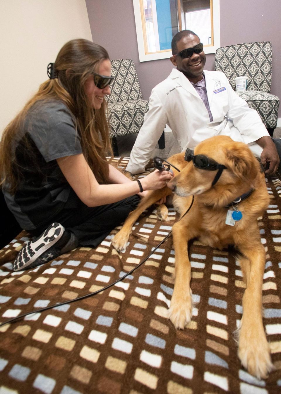 Cortney Gambale (left), a physical therapist assistant, gives