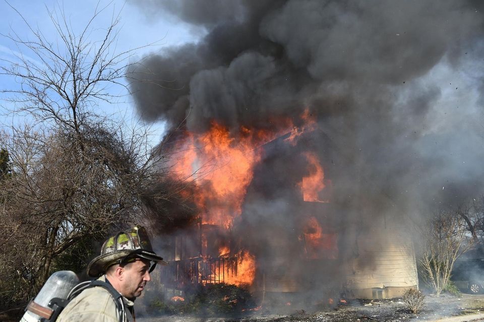 Heavy fire rages from a home at 19
