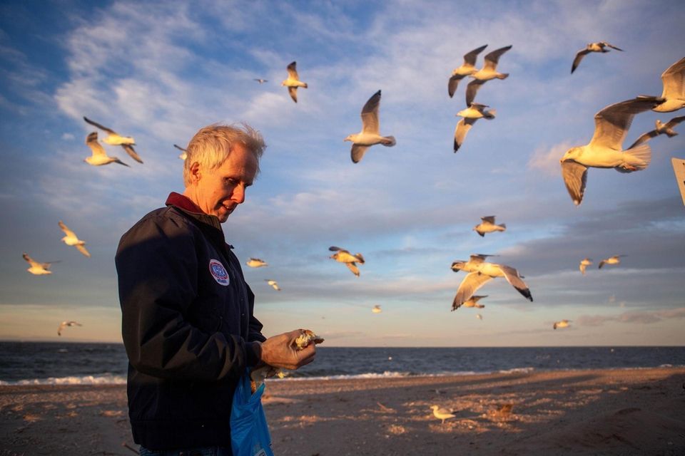 Steven Scott, Rocky Point, feeds the seagulls at