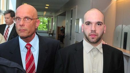Flanked by his attorney William Petrillo, left, taxi