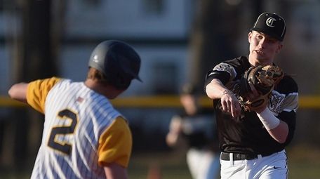 Pat McNelis #22, Commack second baseman, throws to