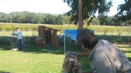 Max Moran assists a painter during last year's