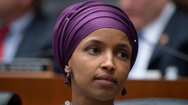 Rep. Ilhan Omar (D-Minn.) sits with fellow Democrats