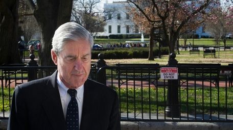Special counsel Robert Mueller walks past the White