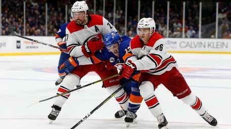 Justin Faulk #27 and Teuvo Teravainen #86 of