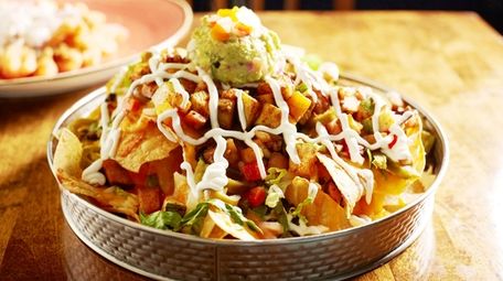 Vegetable nachos topped with melted cheese, pico de
