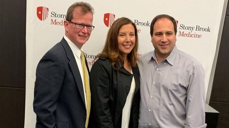 Dr. James Stelling, left, with patients Nicole and