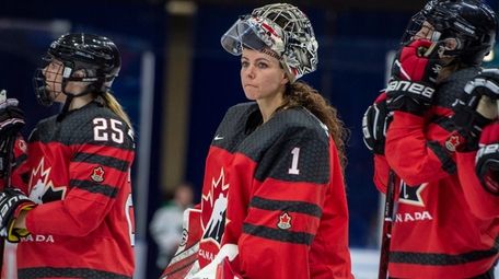 Canada goaltender Shannon Szabados watch as U.S. players