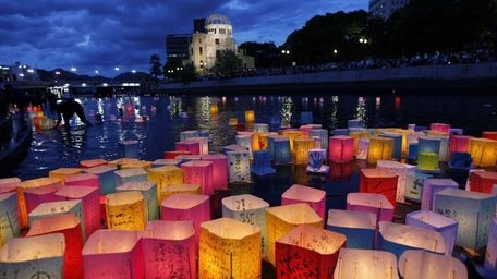 Paper lanterns float along the Motoyasu River in