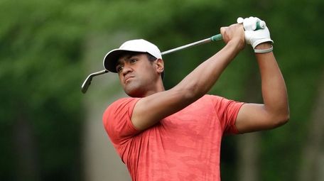 Tony Finau watches his approach shot on the