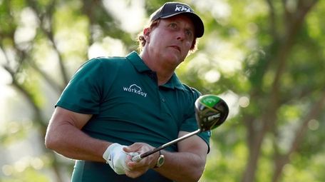 Phil Mickelson watches his tee shot on the