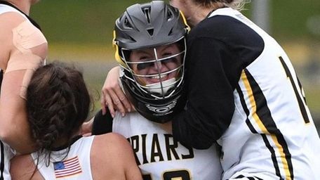 St. Anthony's players mob goalie Erin O'Grady after