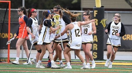 St. Anthony's players celebrate a goal by Katie