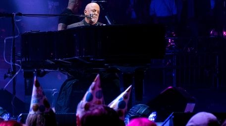 Billy Joel performs during a concert that also