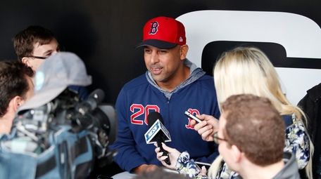 Boston Red Sox manager Alex Cora talks with