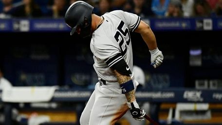 Gleyber Torres of the Yankees gets hit by