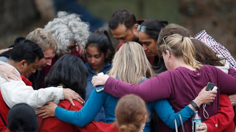 Parents gather in a circle to pray at