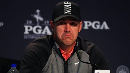 Brooks Koepka speaks with the media during a