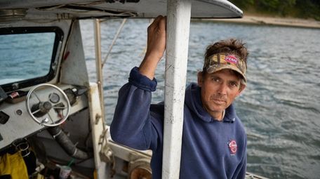 Clam fisherman Bryan Murphy stands on his fishing