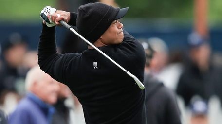 Tiger Woods hits on the driving range during