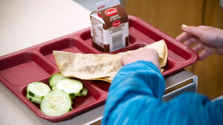 A student eats lunch at William Allen School
