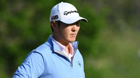Danny Lee waits to putt on the 14th