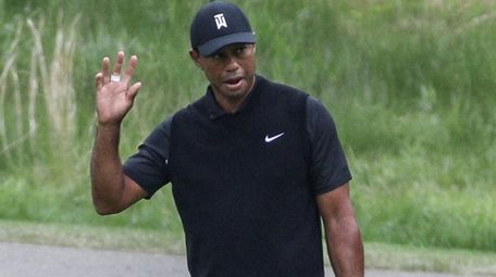 Tiger Woods acknowledges the crowd after sinking his