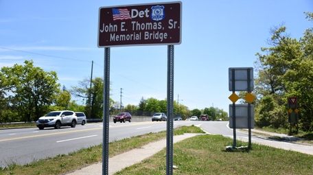 A sign honoring Detective John Thomas, the first