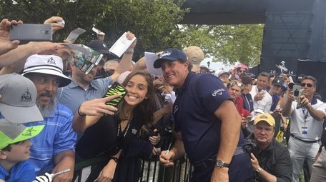 Phil Mickelson with fans on the autograph line