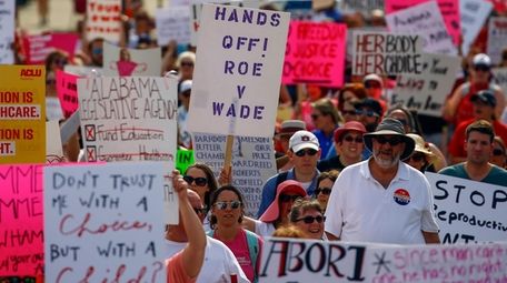Protesters for women's rights march to the Alabama