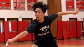 Commack's Andrew Wang with the backhand return against